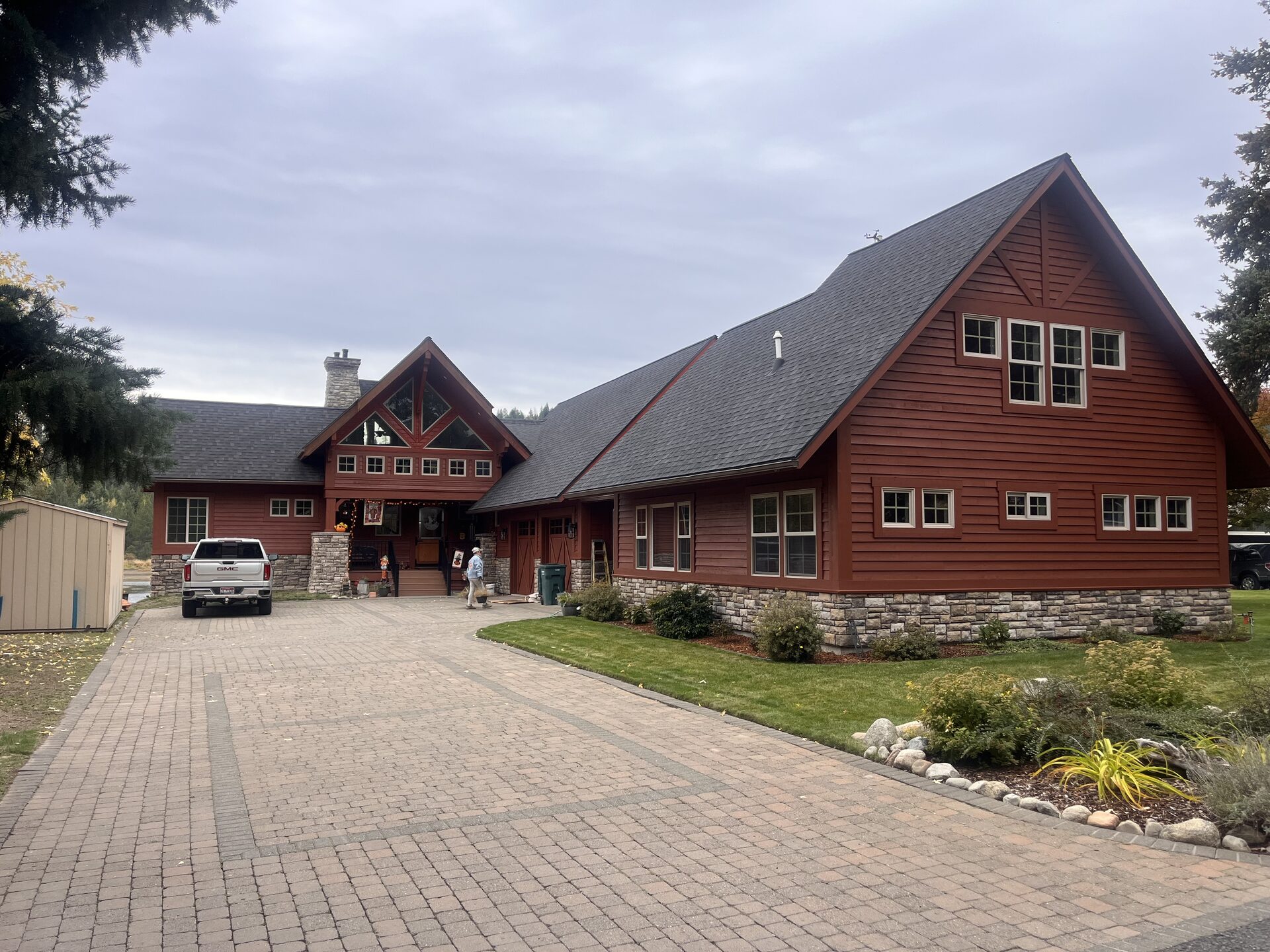 Log home exterior side painting with decorative art North Idaho