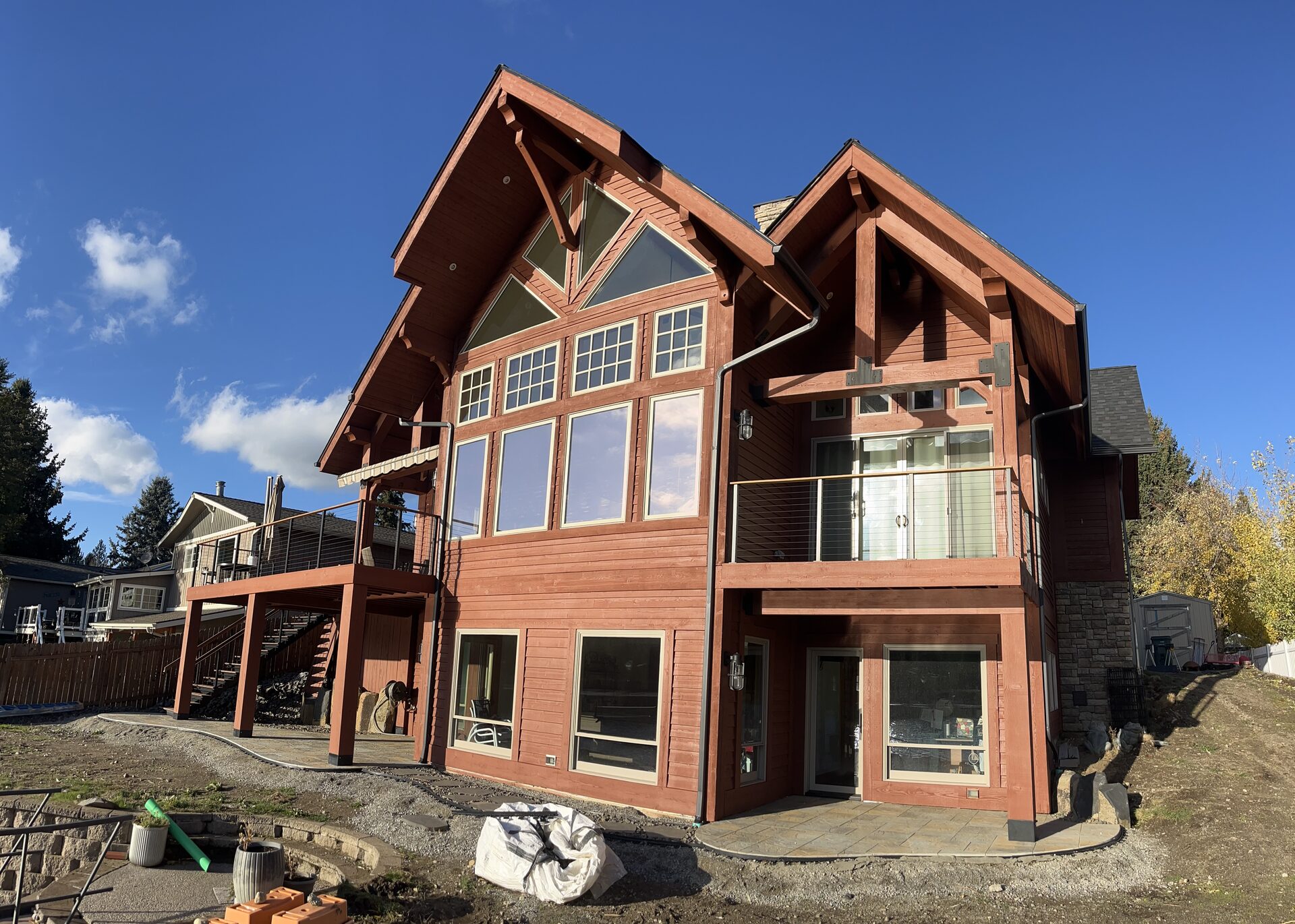 Log home back exterior painting with mountain views North Idaho by Donner Painting