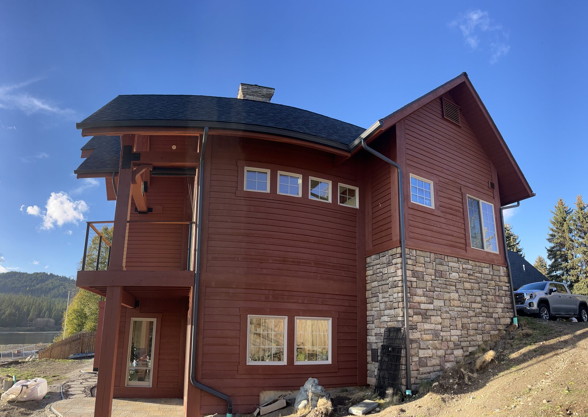 Log home side exterior painting with stone base Coeur d'Alene Idaho
